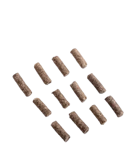 Close-Up Of Cylindrical Paper Cat Litter Pellets On White Background by ISEMIPET