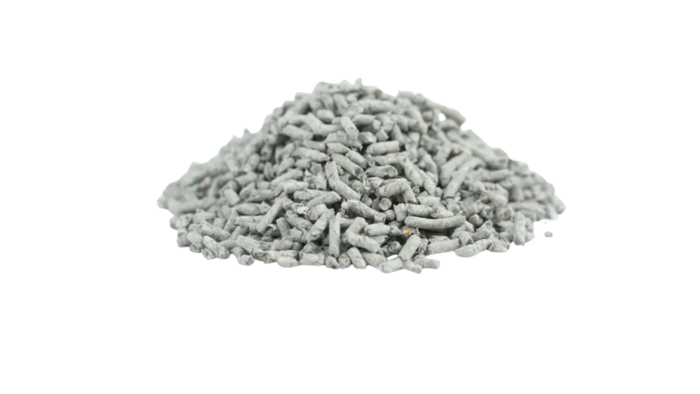 Pile of recycled newspaper cat litter pellets on black background