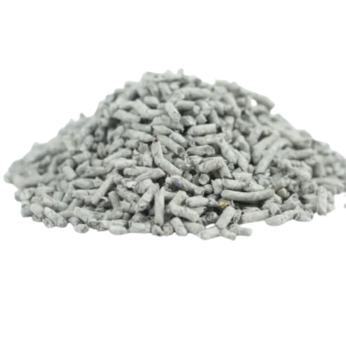 Pile of recycled newspaper cat litter pellets on black background