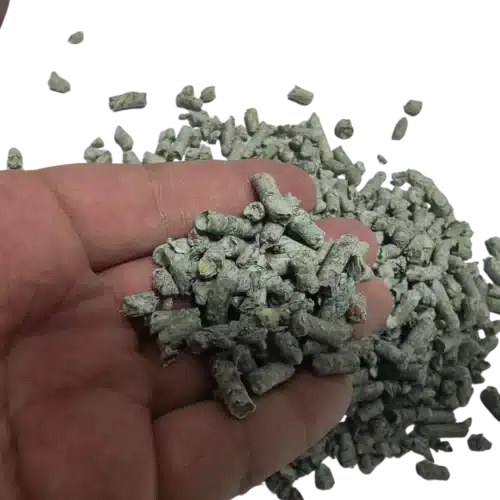 Recycled newspaper cat litter pellets pouring from hand